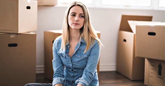 Woman packing boxes in her home after her divorce was finalized